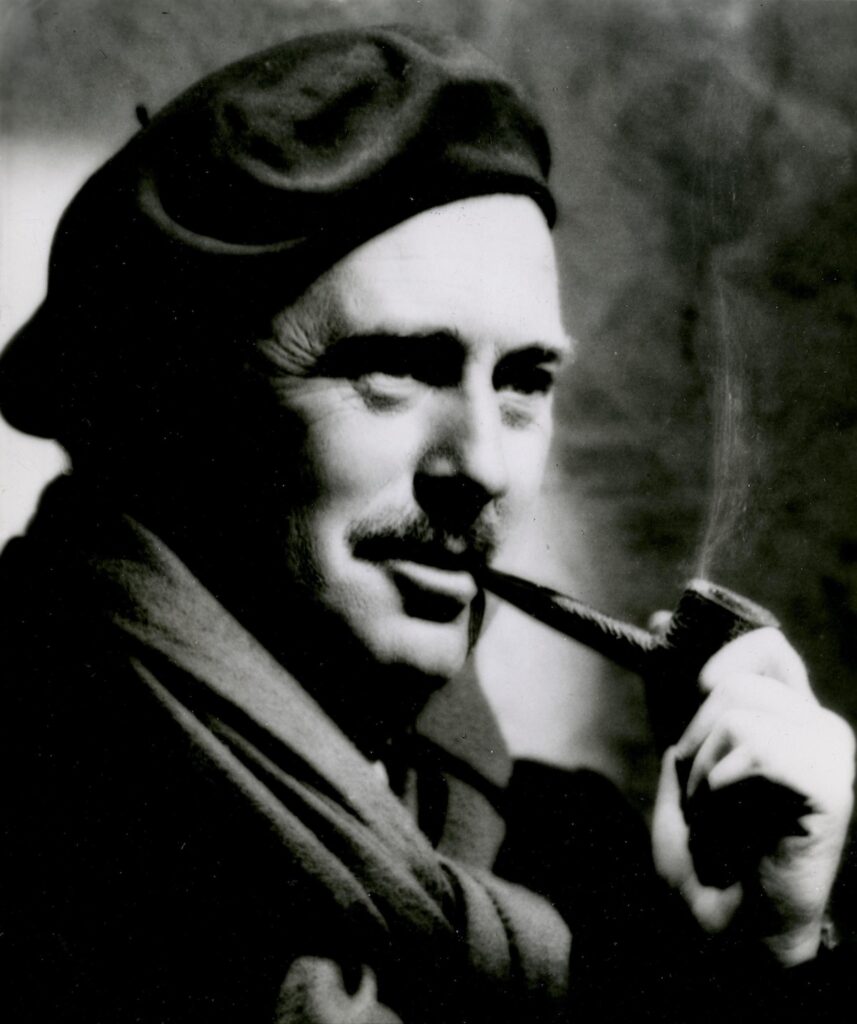 black and white photo of a man smoking a pipe