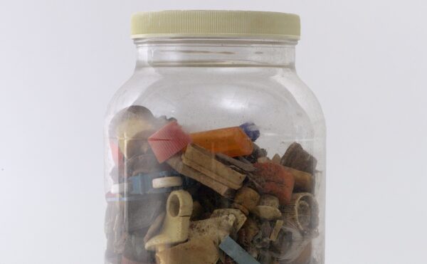 glass jar containing pieces of plastic