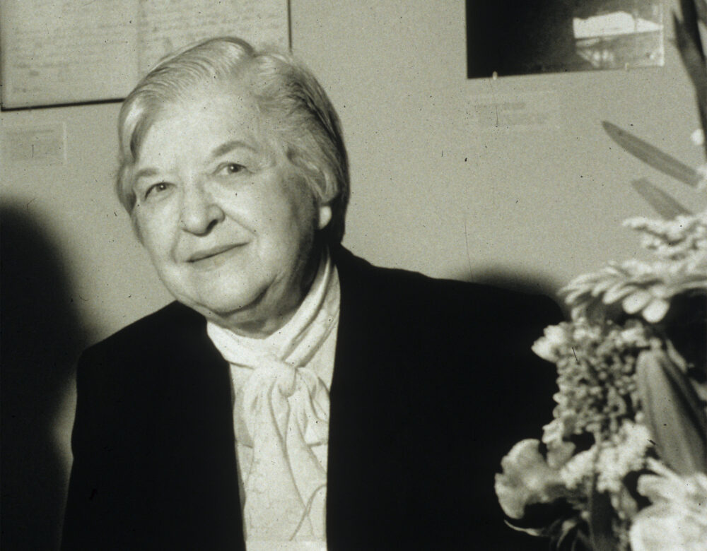black and white photo of Stephanie Kwolek at a table