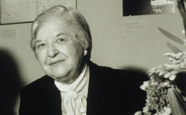 black and white photo of Stephanie Kwolek at a table
