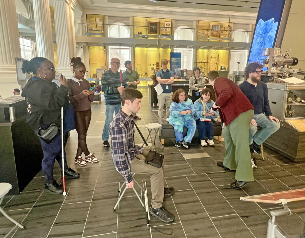 guests and guides gathered near Object Explorer for touch tour