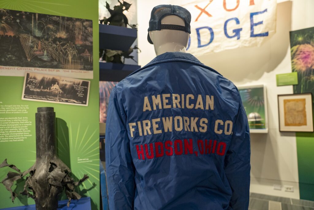 view of an exhibition on fireworks showing a mannequin wearing an American Fireworks Co. jacket