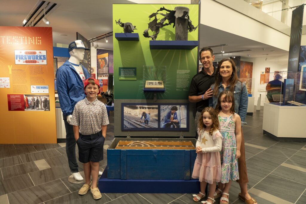 Roberto Sorgi, owner of American Fireworks, and his family pose in front of the home run fireworks box used by his father at baseball games