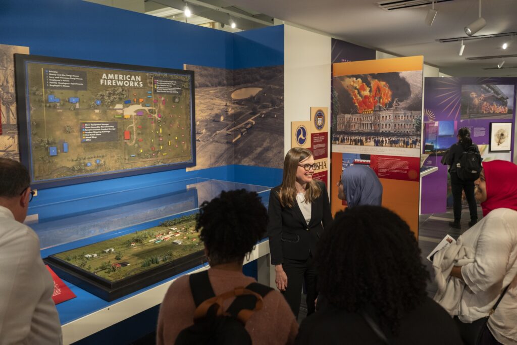 people viewing a display of an exhibition on fireworks at the Science History Institute