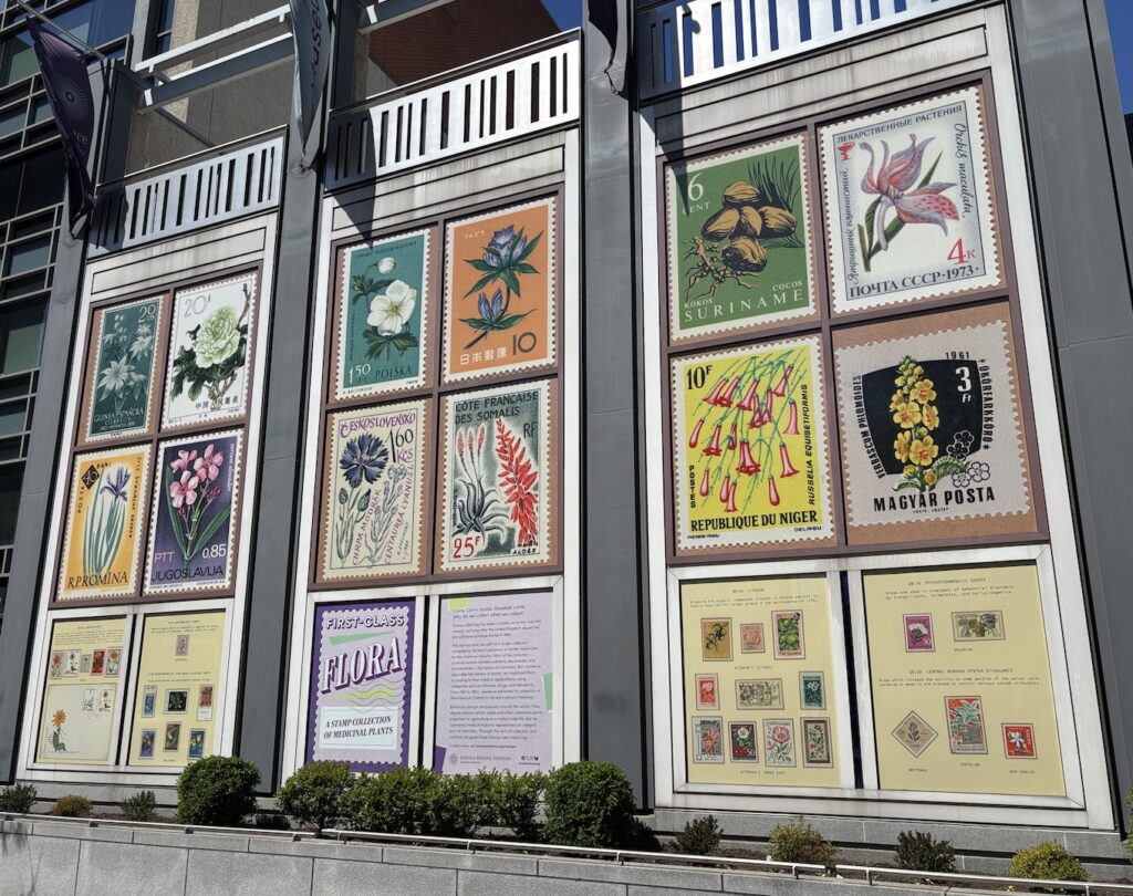 View of the exterior of a building featuring an exhibit of floral postage stamps