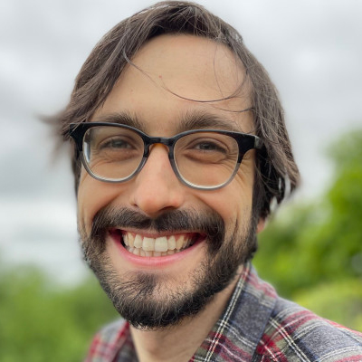 Jonah Walters, smiling, wearing glass, outdoors