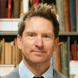Lucas Richert in front of library stacks