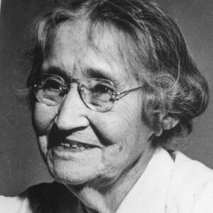 black and white of a women holding up a herbarium