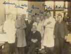 sepia-toned group photo of men in suits and lab coats