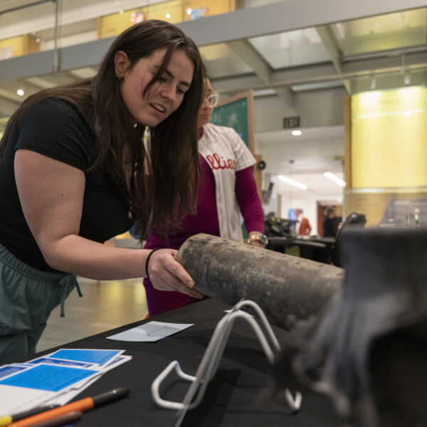 visitor touching an inert firework shell