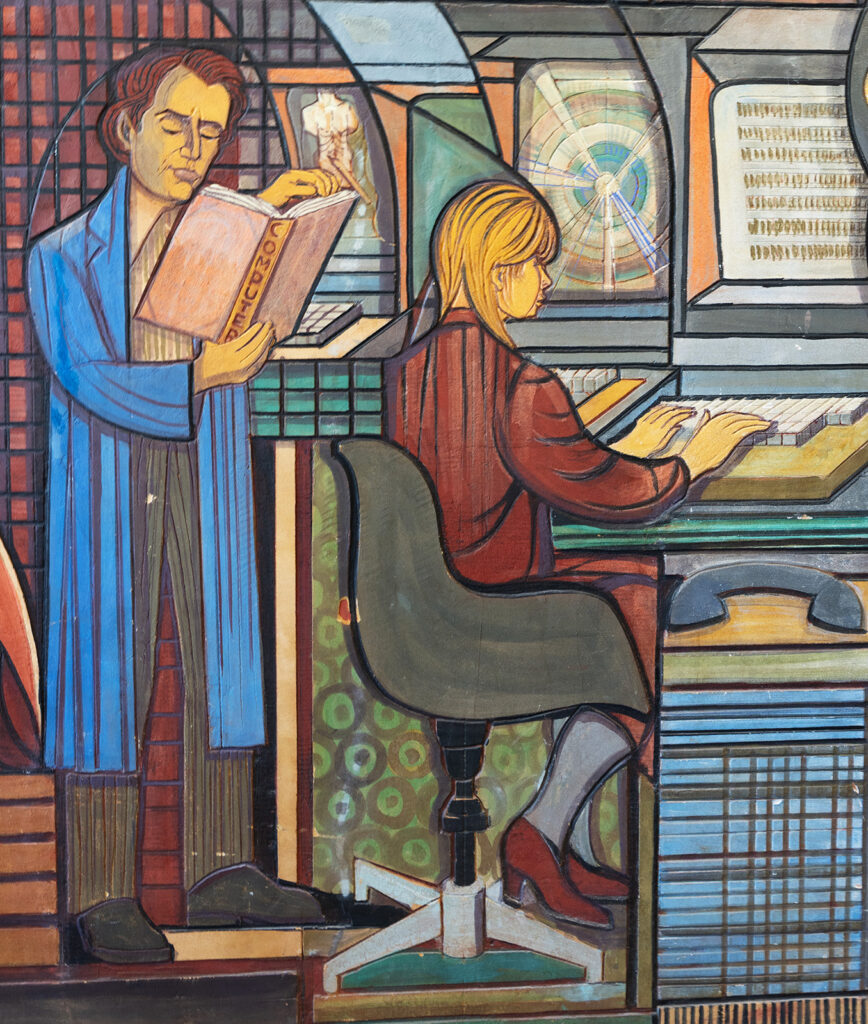Colorful painting of a woman typing at a computer and a man, standing behind her reading a book labeled “computer.”