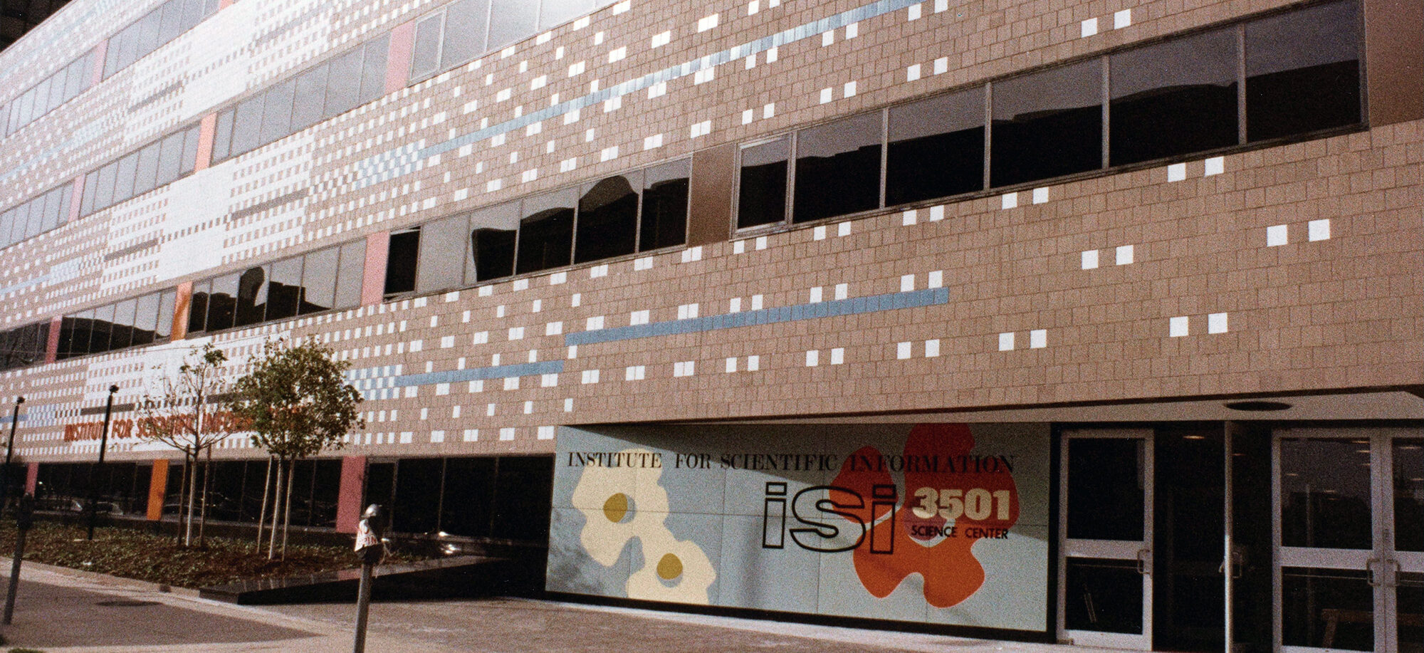 Large brick building with colored decorative tiles.