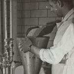 man pouring raw material into a funnel