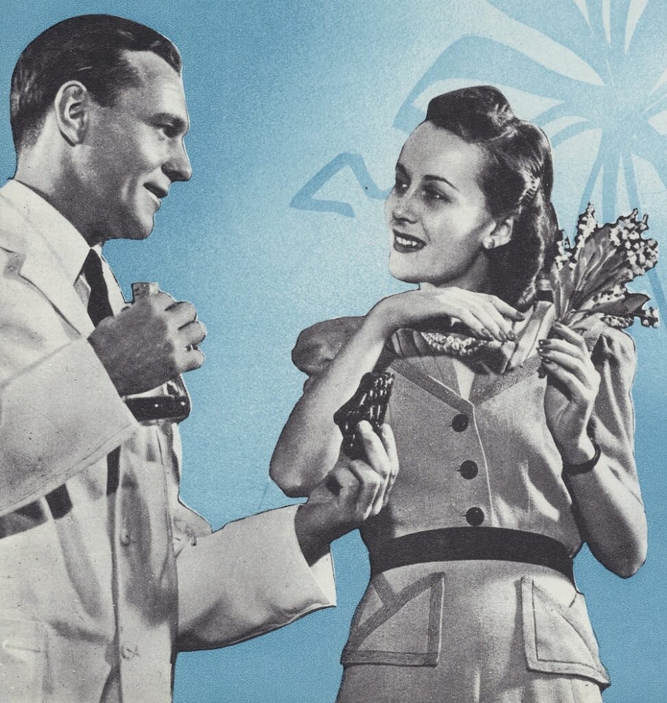 man in lab coat talking to a woman holding flowers