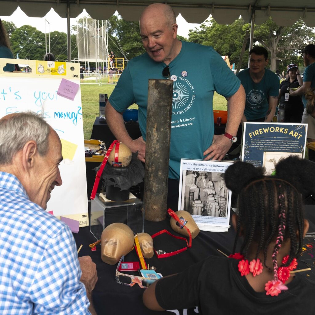a man and a child sit at an activity table