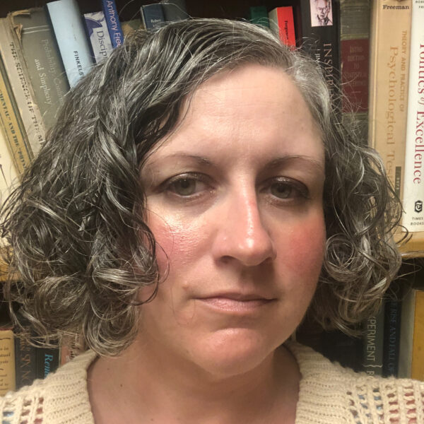 Ann Campbell in front of a bookcase