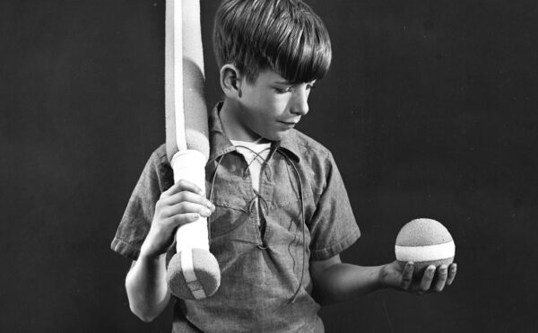 Photo of a boy posed with Styrofoam ball and baseball bat, 1966.