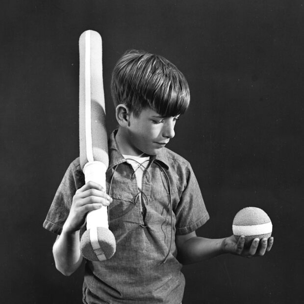 Photo of a boy posed with Styrofoam ball and baseball bat, 1966.