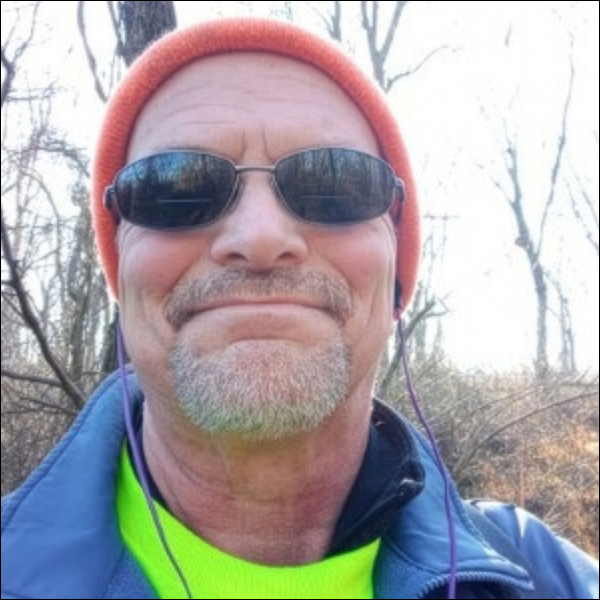 Roland Wall, in hat and sunglasses, outdoors in winter