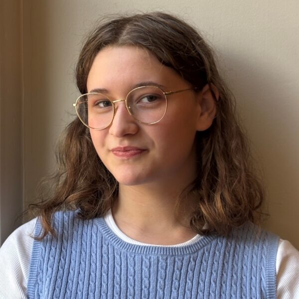 photo of a person wearing glasses and a blue and white shirt