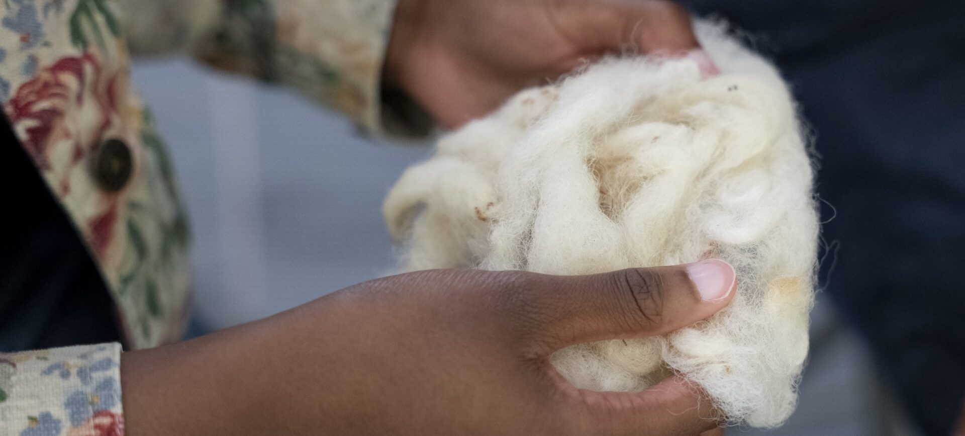 person holding a ball of cotton fabric