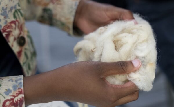 person holding a ball of cotton fabric