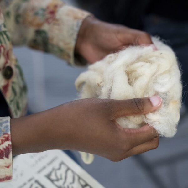 person holding a ball of cotton fabric