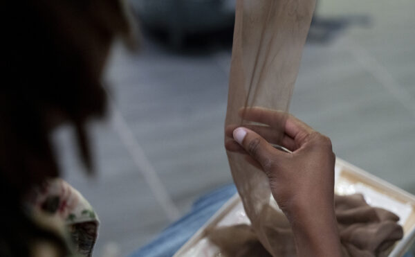 right hand touching a nylon stocking