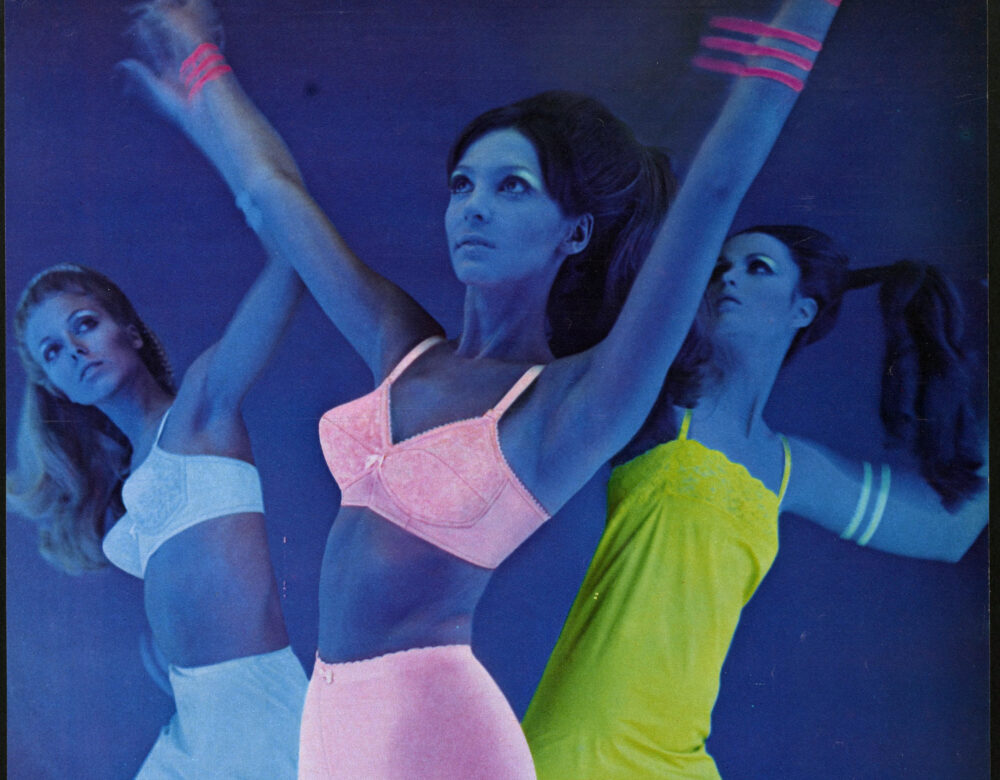 ad depicting dancers in neon undergarments under black light