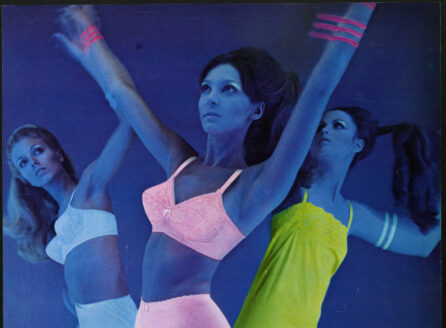 ad depicting dancers in neon undergarments under black light