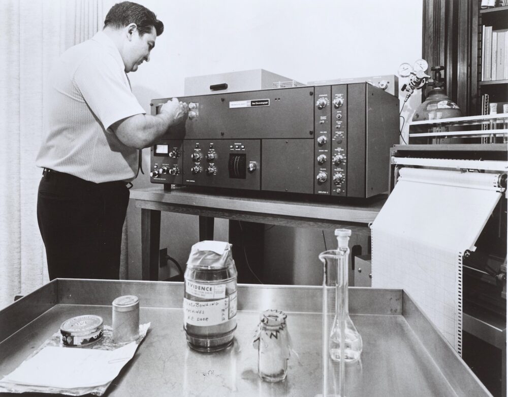 black and white photo of a man using a chromatagraph
