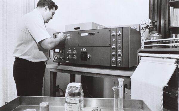 black and white photo of a man using a chromatagraph