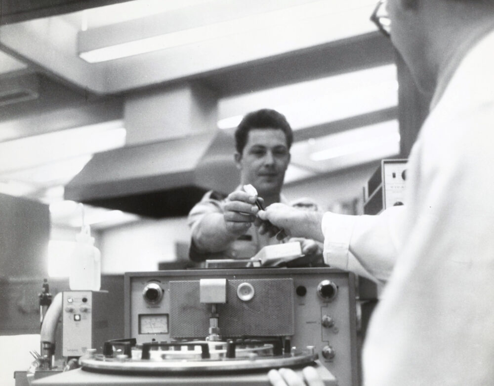 black and white photo of men with lab equipment