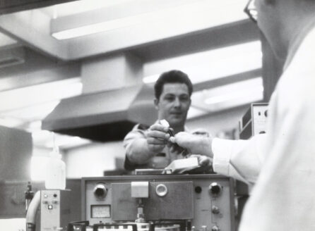 black and white photo of men with lab equipment