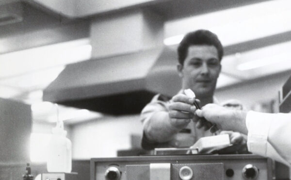 black and white photo of men with lab equipment
