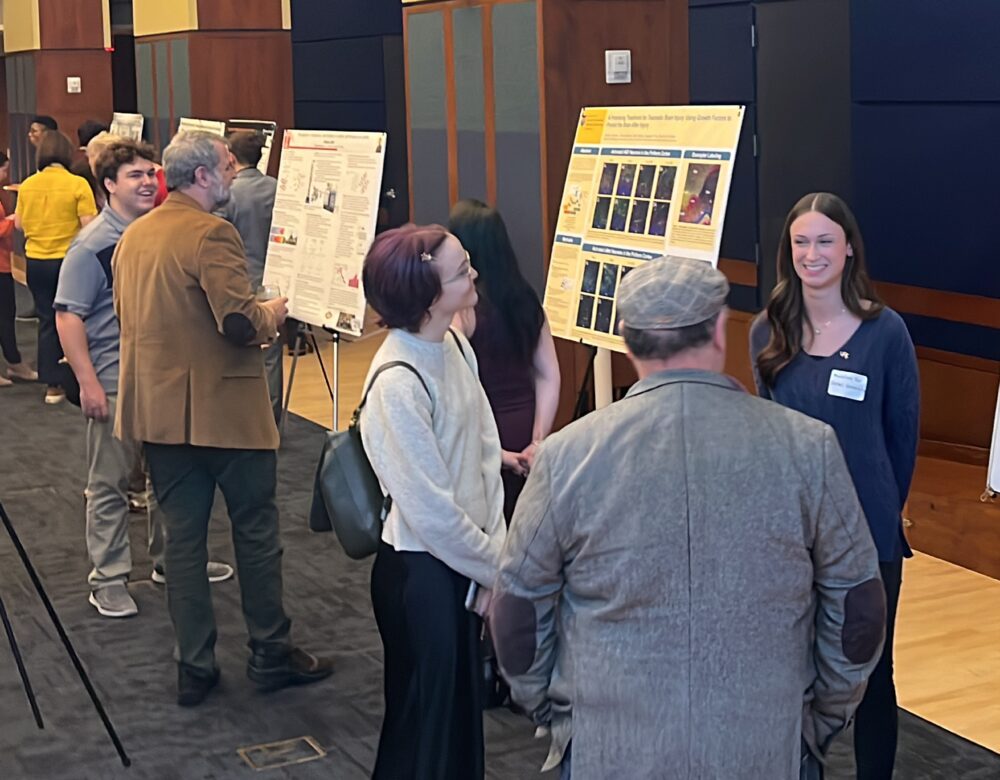 gathering of people interacting with science posters