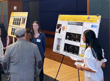 gathering of people interacting with science posters