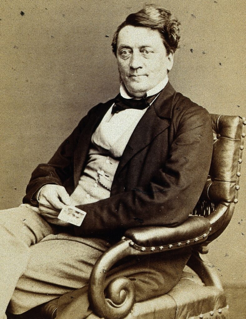 sepia-toned portrait of a man sitting in a chair