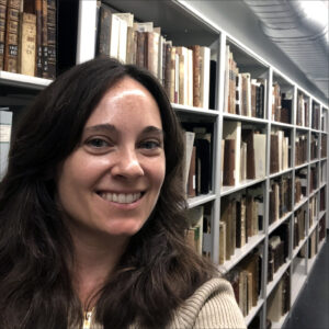 Briana Giasullo in front of book stacks