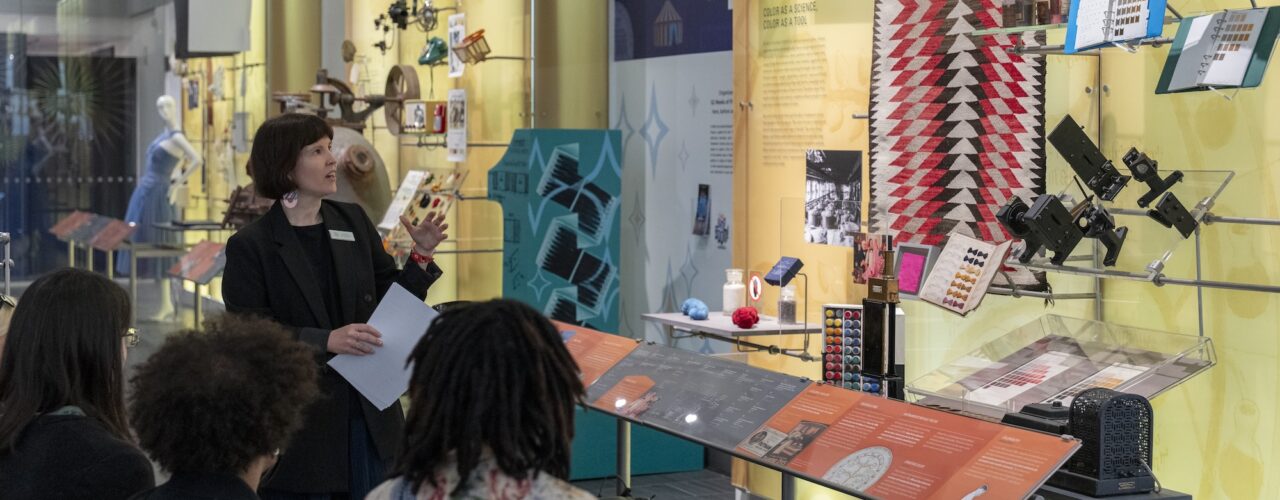 museum guide points out exhibits to visitors