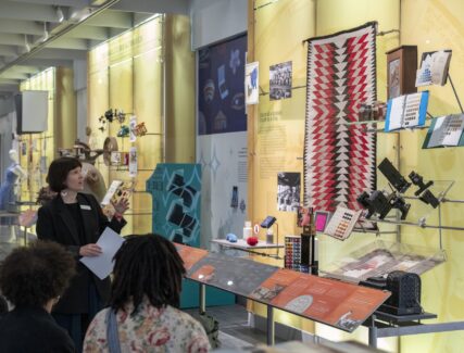museum guide points out exhibits to visitors