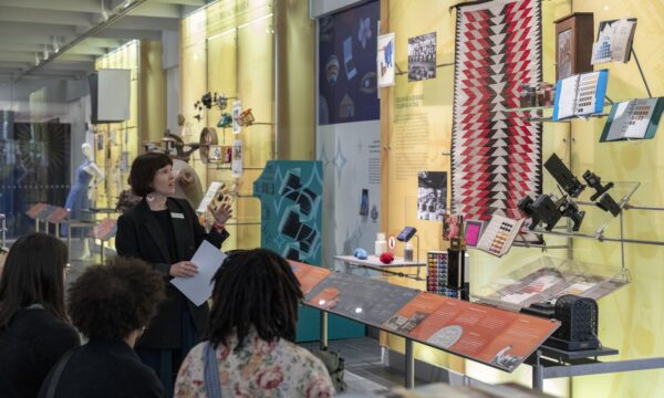 museum guide points out exhibits to visitors