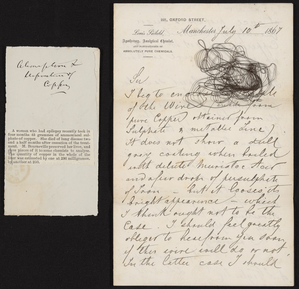 newspaper clipping, wire, and handwritten note