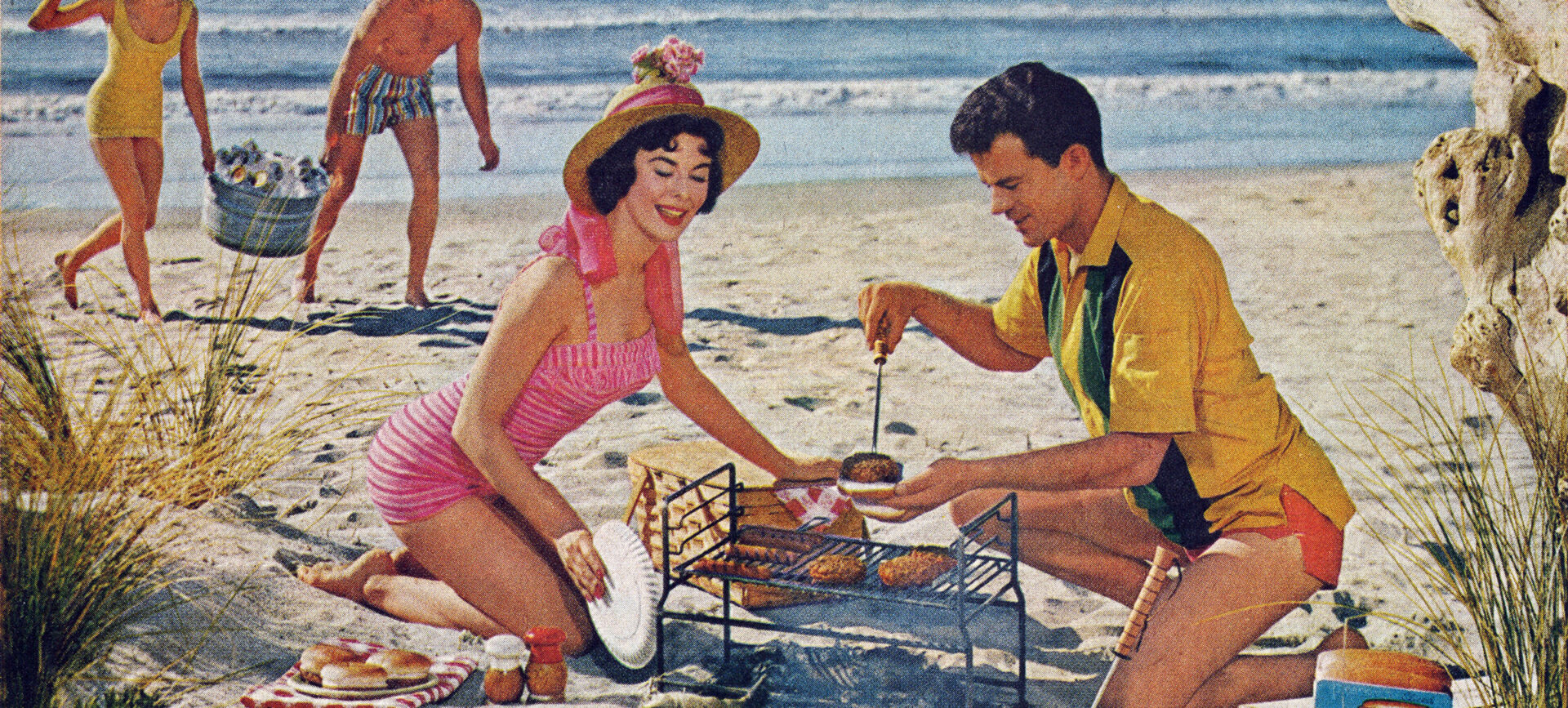 Advertising photo of a man and woman grilling on a beach