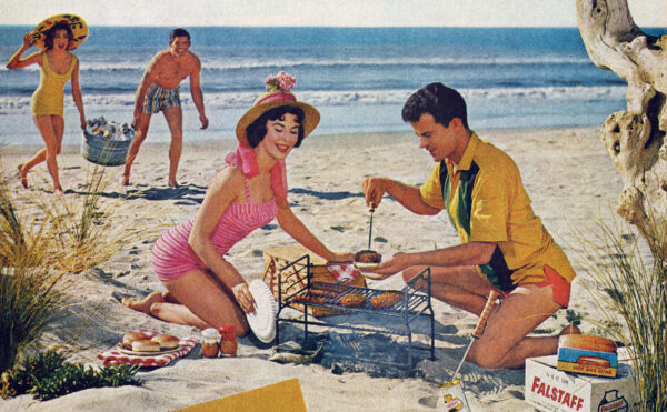 Advertising photo of a man and woman grilling on a beach