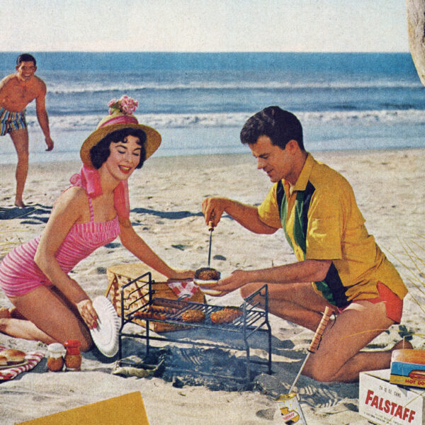 Advertising photo of a man and woman grilling on a beach