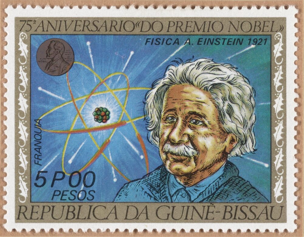 postage stamp depicting a drawing of Albert Einstein, along with a Nobel Prize medal and an atom.