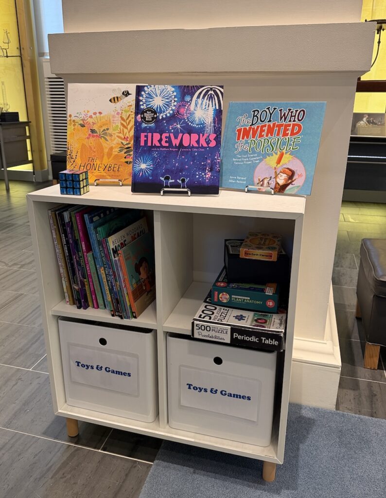 shelf filled with children's books and games