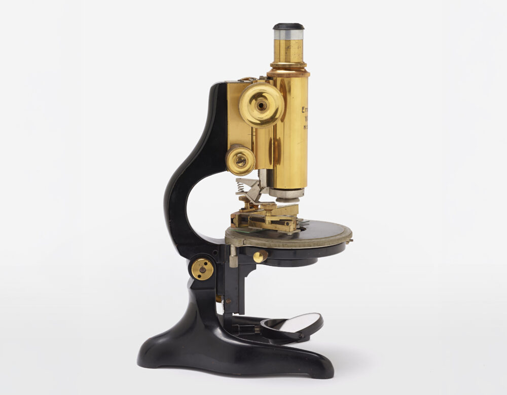 brass and black microscope