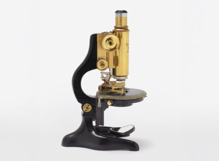 brass and black microscope